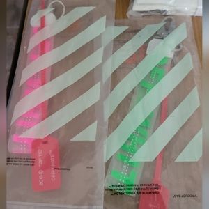 His and hers off-white caribiner lanyards with zip ties and parts bag